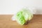 Iceberg lettuce vegetable in plastic bag. single use plastic packaging issue