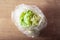 Iceberg lettuce vegetable in plastic bag. single use plastic packaging issue