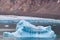 Iceberg next to the edge of a glacier in Ellesmere Island, part of the Qikiqtaaluk Region in the Canadian territory of