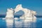 Iceberg in the ocean. Blue sky. Disko Bay, Western Greenland.