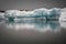 Iceberg reflected on the water under a gloomy sky