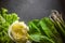 Iceberg salad, green onions and spinach on gray slate