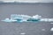 Iceberg shining in white, turquoise color in dark blue Southern Antarctic Ocean, Antarctica