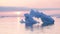 Iceberg at sunset. Nature and landscapes of Greenland. Disko bay. West Greenland. Summer Midnight Sun and icebergs. Big blue ice