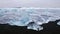 Icebergs floating on black volcanic beach, South Iceland