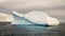 Icebergs floating in the ocean near the snowy peaks of Antarctica.