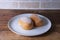 Iced Buns on the white dish on wooden background