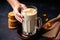 iced chai latte served with biscuits in human hands