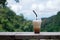 Iced coffee on balcony with Mae Kampong village background