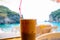 Iced coffee Frappe against sea background in Paleokastritsa, Corfu island, Greece