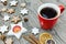 Iced cookies with cinnamon, slices of orange and cup of coffee o