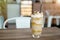 Iced frappe with whipped cream and caramel syrup, with straws and grains of coffee in a tall glass on the wooden table, cold