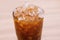 Iced honey lemon tea in glass background close up