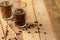 Iced iced coffee in large transparent glasses, poured over milk, with coffee beans on a wooden background, summer cooling drink,