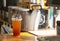 Iced lemon tea in plastic glass on wooden counter inside of mini coffee shop on street