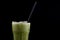 Iced macha green tea isolated from black background.