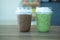 Iced matcha green tea latte and iced coffee mocha in take away glass