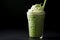 Iced Matcha Latte with Milk in Latte Glass on Black Background