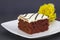 Iced red velvet cake on white platter accented with yellow