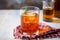 iced tea in a cylindrical glass with a handle, on a linen napkin