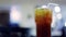 Iced tea with lime slice and blurred restaurant background