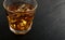 Iced Whiskey Glass on Natural Black Stone Background