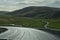 Iceland: agricultural fields, river, mountains and curvy roads