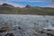 Iceland arrival of a glacier in green and brown mountain background