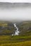 Iceland. East fjords. River and rocks with fog.