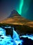Iceland famous mountain Kirkjufell with aurora borealis Northern Light with waterfall in winter