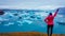 Iceland - Girl at the glacier lagoon with her hand rised up