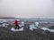 Iceland - A girl pretending to surf at the ice berg on black sand beach