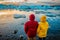 Iceland glacier landscape tourists couple at Jokulsarlon lake. Winter adventure hiking people