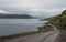 Iceland gravel road winding through scenic fjord