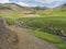 Iceland, Hveragerdi, August 5, 2019: Crowded natural geothermal bath in a Hot River stream in Reykjadalur Valley with