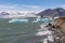 Iceland Jokulsarlon glacier lagoon with tourists admiring icebergs in lake