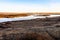 Iceland landscape with river and gray grass