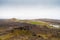 Iceland lighthouse Reykjanesviti with rocky volcanic soil gesers and grey sky