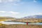 Iceland nature hiking travel adventure wanderlust. Hiker girl walking across lava fields in amazing dramatic icelandic