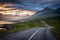 Iceland road landscape with clouds and amply field