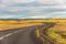 Iceland road landscape with clouds and emply field