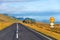 Iceland road landscape with clouds and emply field