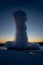 Iceland\\\'s great geyser Strokkur in full eruption with mist and smoke backlit and the last light of the orange sunset