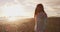 Iceland scene. Woman in traditonal icelandic sweater walking on Reynisfjara black sand beach by Vik South Iceland coast