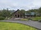 ICELAND, THORSMORK, August 3, 2019: Wooden cottage of Basar mountain hut and camp site with grass meadow, boardwalk and birch