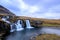 Iceland timelapse photography of waterfall and famous mountain. Kirkjufellsfoss and Kirkjufell in northern Iceland nature