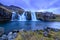 Iceland timelapse photography of waterfall and famous mountain. Kirkjufellsfoss and Kirkjufell in northern Iceland nature