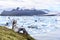 Iceland tourist enjoying Jokulsarlon glacial lagoon. Woman visiting destination landmark attraction glacier lake, Iconic