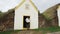 Iceland Tourist by Old Farmhouse Laufas Glaumbaer farm Museum turf roof house