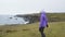 Iceland tourist on travel walking and hiking on Arnarstapi Snaefellsnes